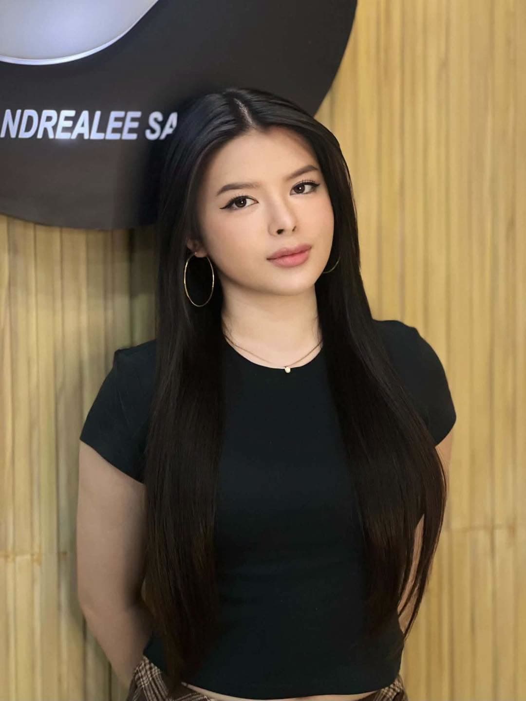 Client with long, healthy, glossy black hair at SandreaLee Salon