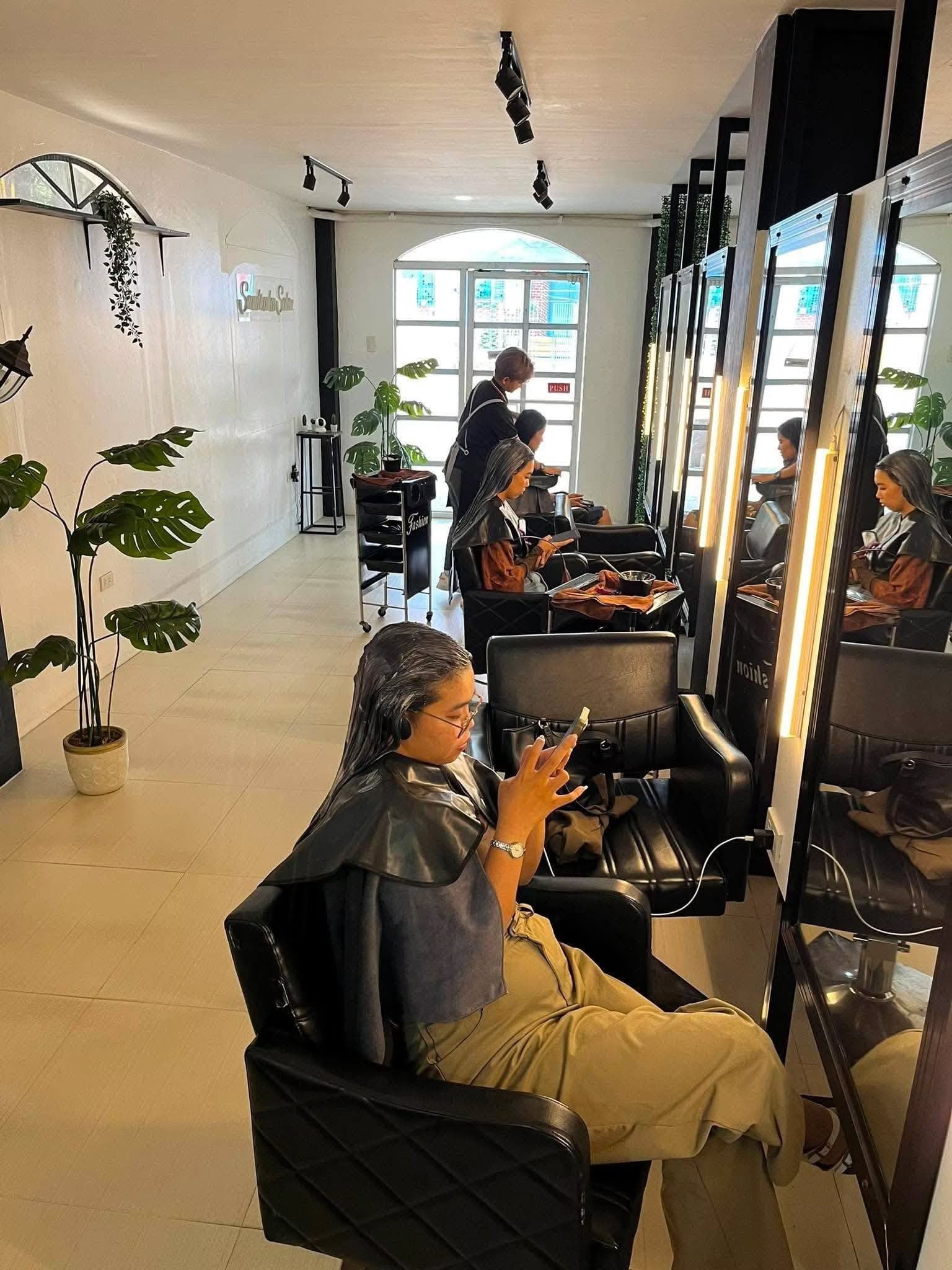 A bright SandreaLee salon floor with clients at the mirrors