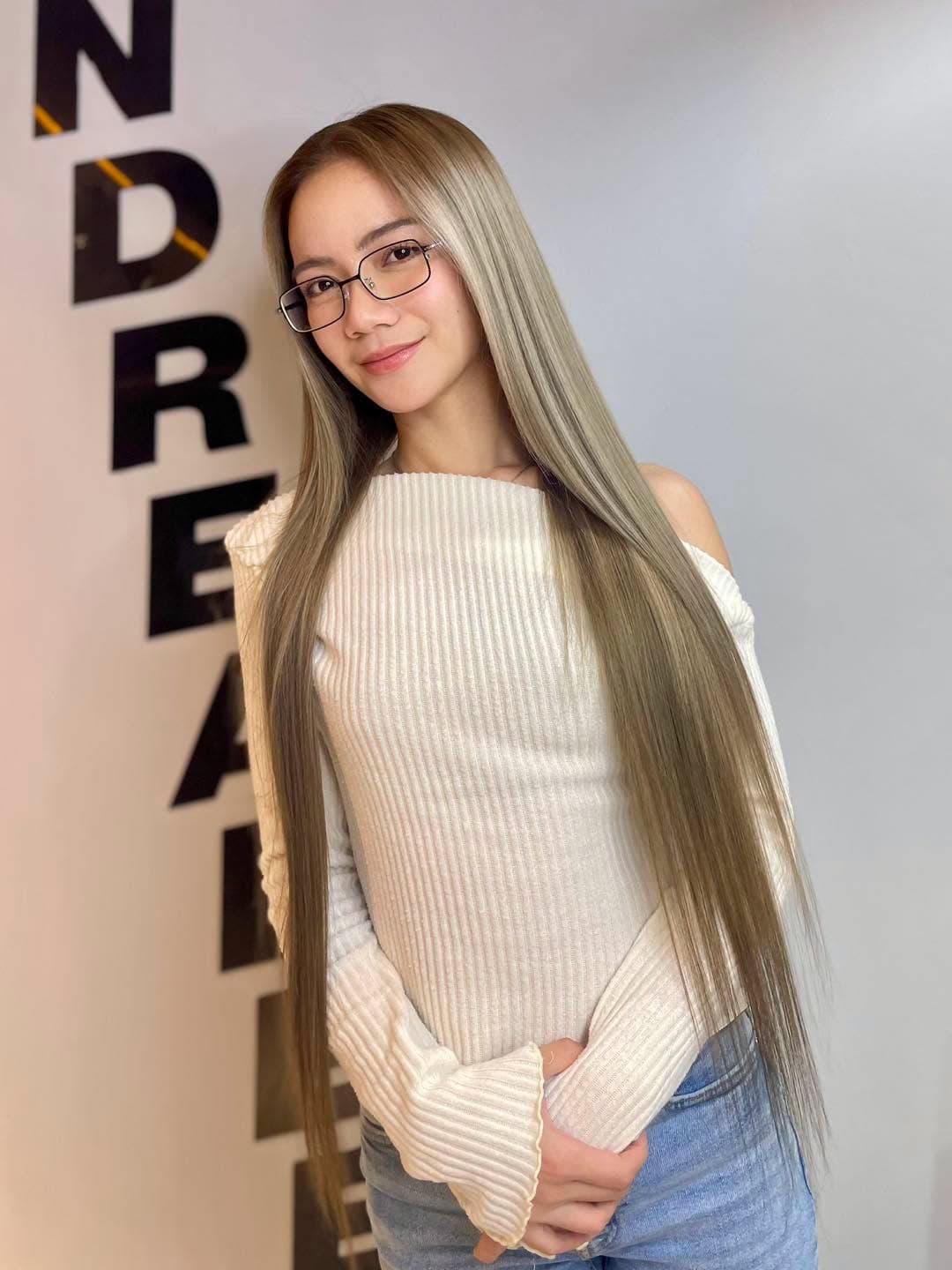 Client with very long, sleek ash hair at SandreaLee Salon